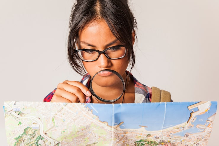 A person thoughtfully looking at a complex map, symbolizing finding answers in the Splinteredfog FAQ service